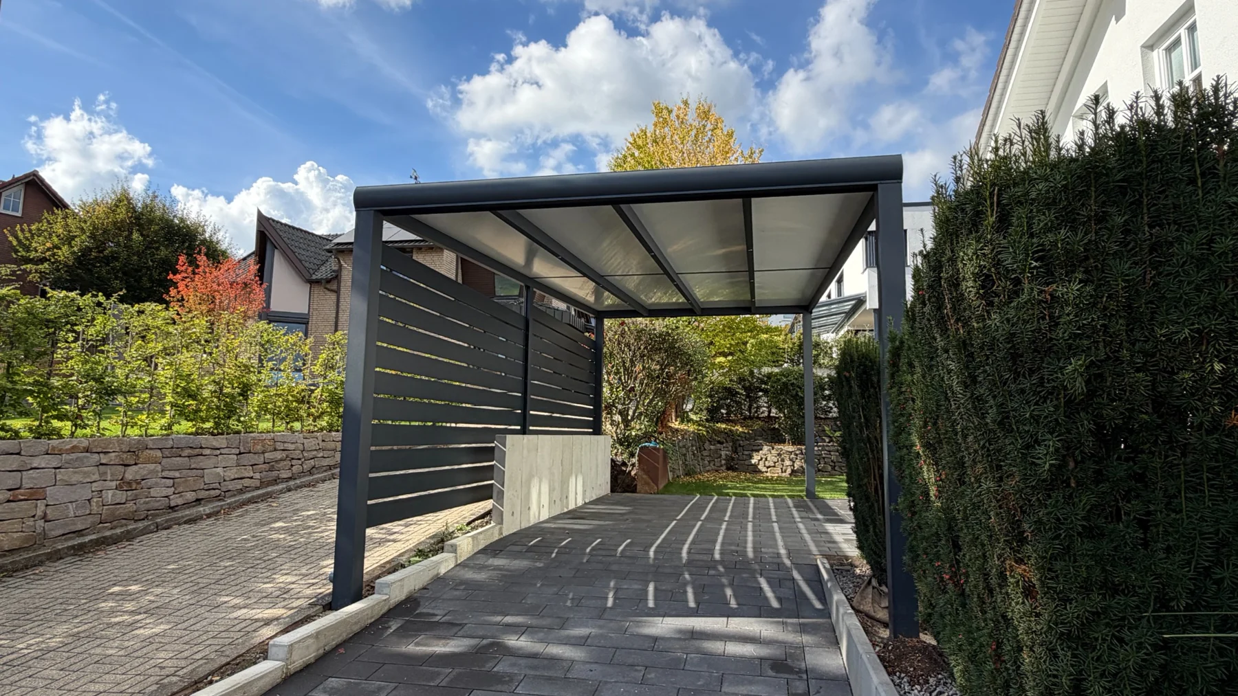 Freistehender anthrazitfarbener XL-Carport mit Sandwichdach und seitlichem Sichtschutz in Schwerte